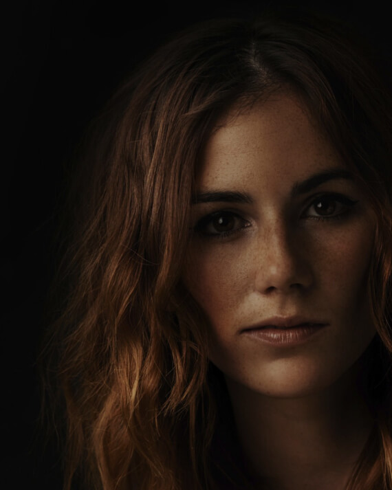 headshot of long brown haired women with light freckles 